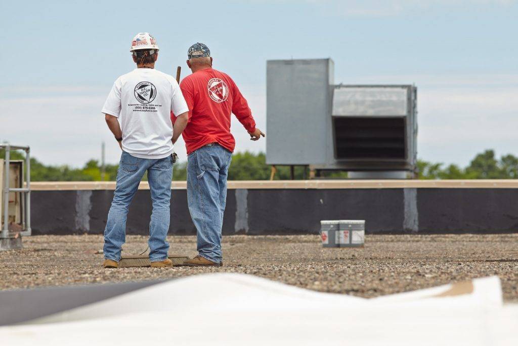 two d. c. taylor co employees having a discussion on a rooftop