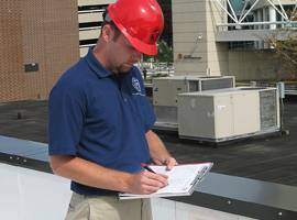 Roofing contractor conducting general preventive roof maintenance - D. C. Taylor Co.