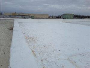 The roof of a manufacturing facility with hail damage.