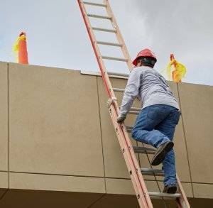 dc taylor co employee climbs up an extension ladder