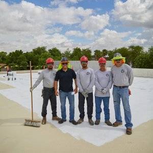 five dc taylor co employees smiling for a picture on a flat roof