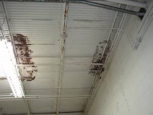 inside of a metal roof that is beginning to rust due to water leak